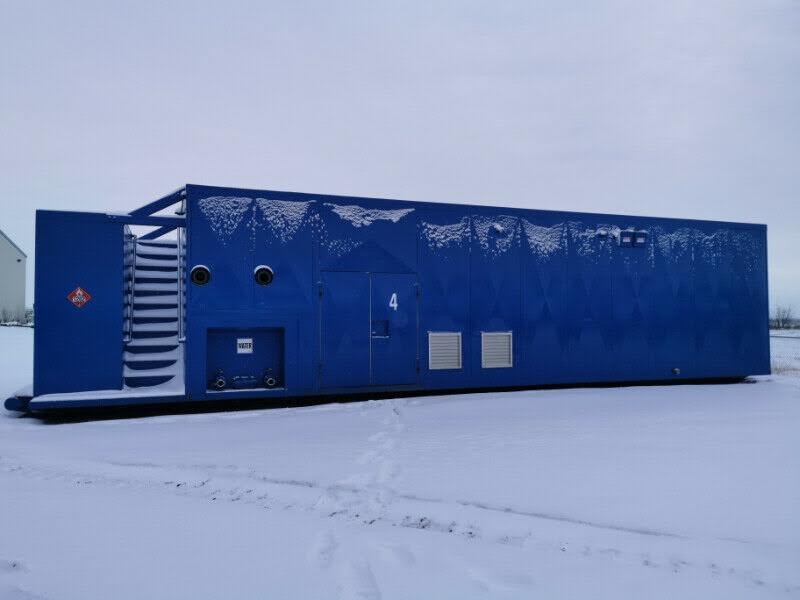 Portable rental boiler building contains 600HP firetube boiler, water tank and fuel tank